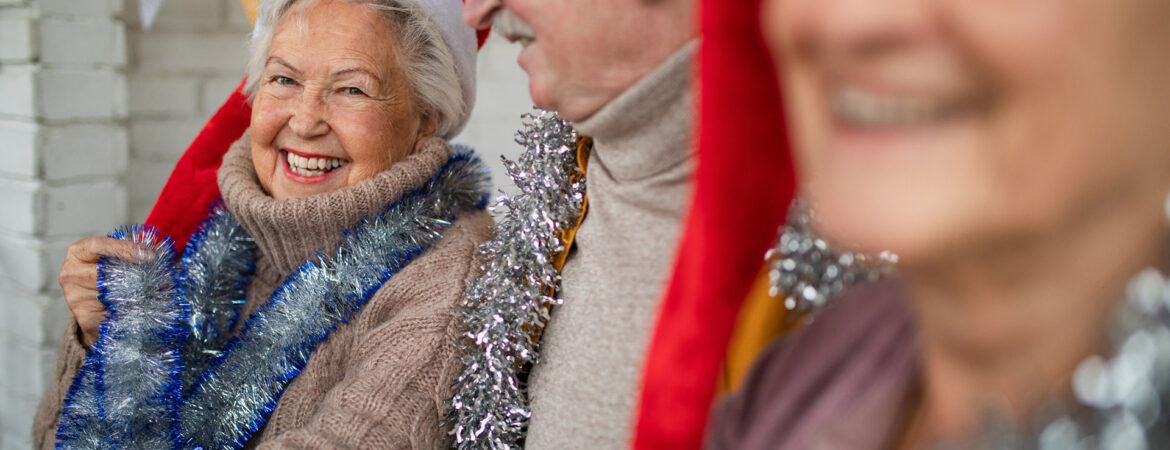 three seniors in santa hats at a party